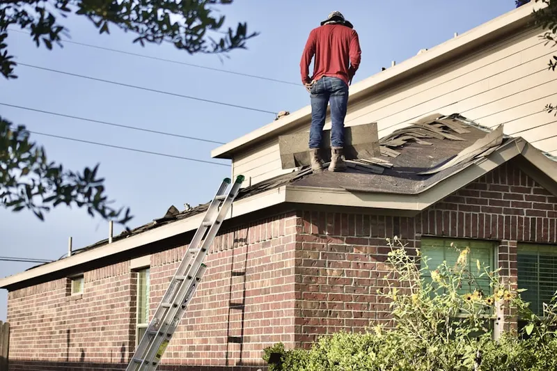 Professional roofer working on a residential roof in Tall Pines Village